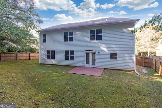 rear view of house featuring a yard and a patio area