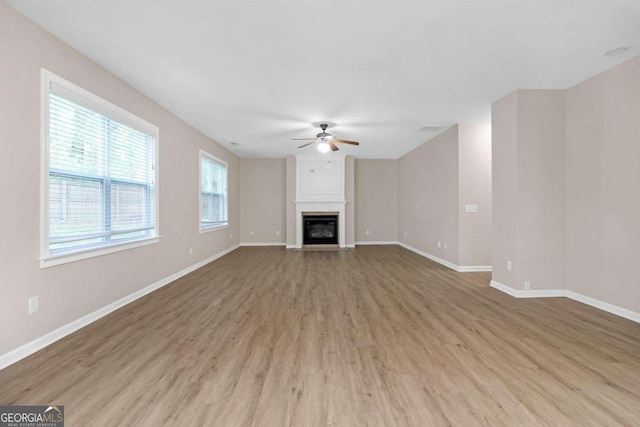 unfurnished living room with light hardwood / wood-style floors and ceiling fan