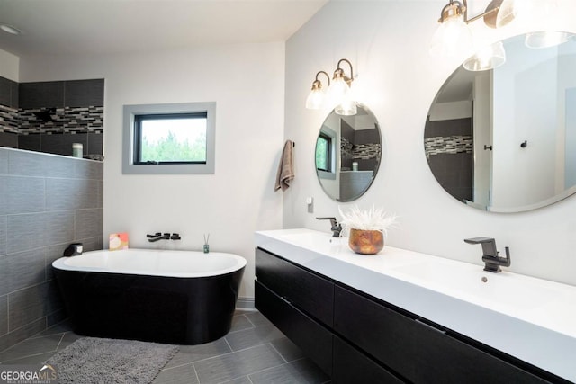 bathroom with vanity, tile patterned floors, and a tub