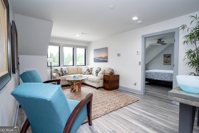 living room with ceiling fan and hardwood / wood-style floors