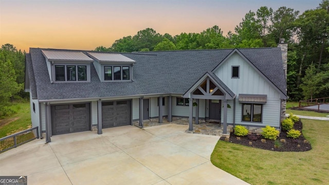 view of front facade featuring a garage and a lawn