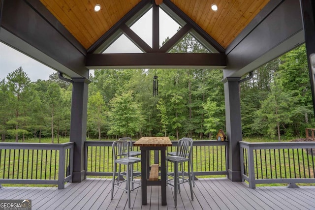 wooden terrace featuring a yard