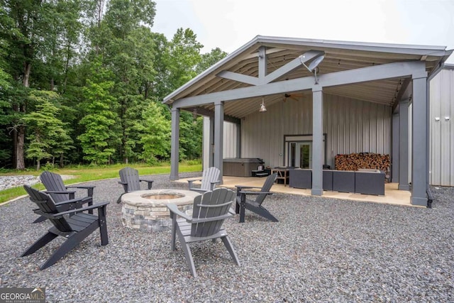 view of patio with an outdoor fire pit and ceiling fan