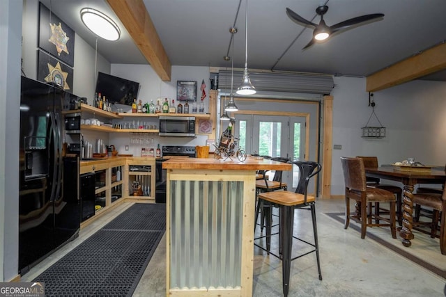 kitchen featuring black appliances, ceiling fan, beamed ceiling, wooden counters, and decorative light fixtures