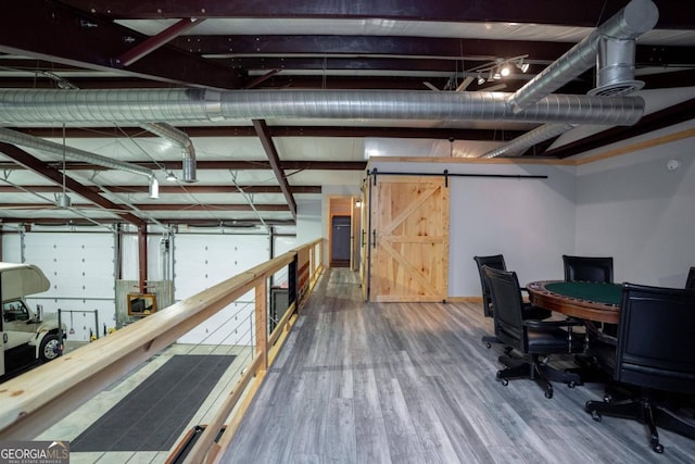 interior space featuring a barn door and wood-type flooring