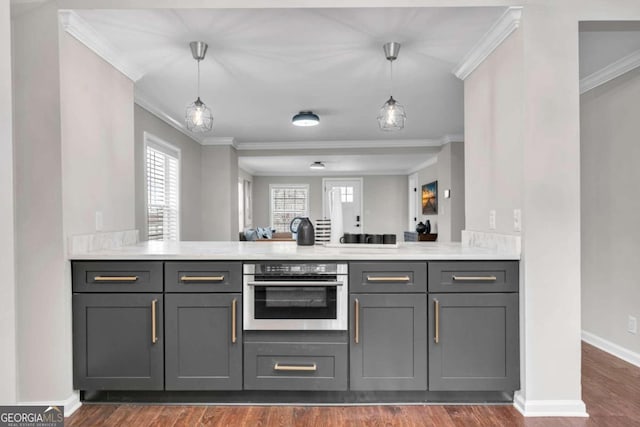 kitchen with dark wood-type flooring, crown molding, stainless steel oven, and gray cabinetry