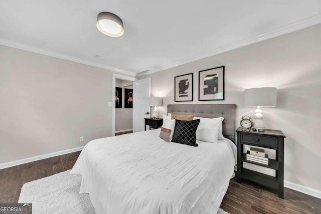 bedroom featuring crown molding and dark hardwood / wood-style flooring