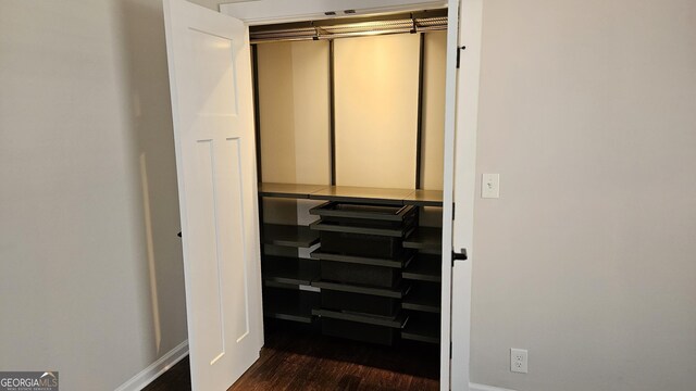 spare room featuring crown molding and dark hardwood / wood-style flooring