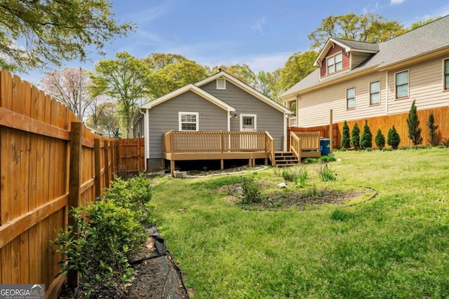 back of house with a yard and a deck