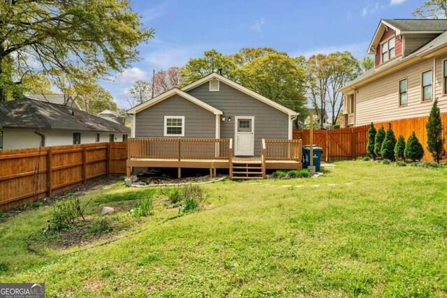 rear view of property with a lawn