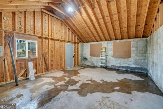 interior space with lofted ceiling and concrete floors