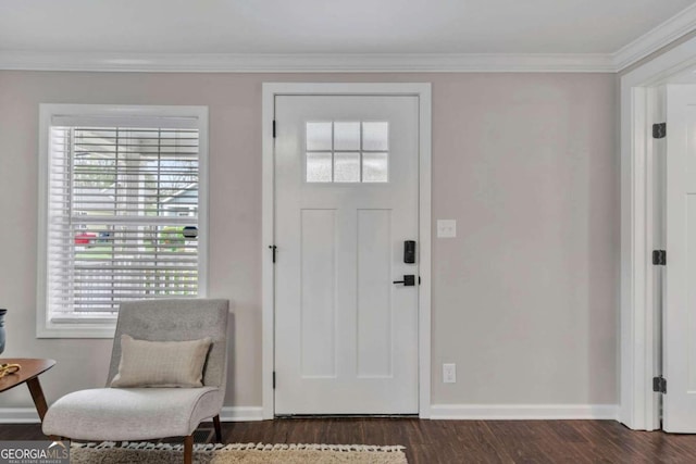 foyer featuring dark wood-style flooring, crown molding, and baseboards