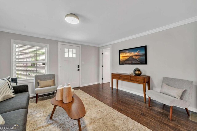 living room with dark hardwood / wood-style floors and crown molding