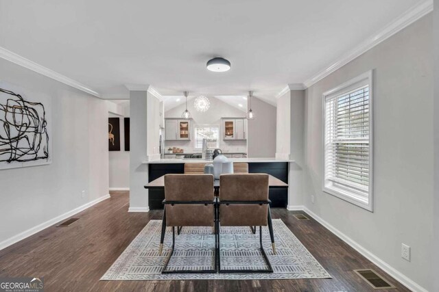 dining room featuring crown molding and dark hardwood / wood-style flooring