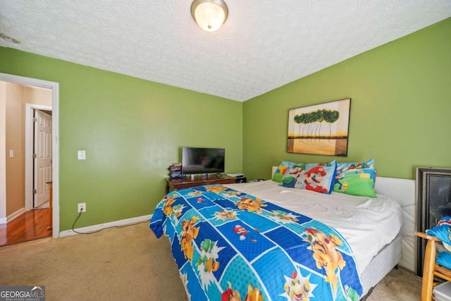 bedroom featuring carpet floors, vaulted ceiling, and a textured ceiling