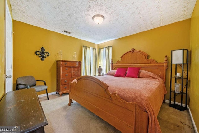 carpeted bedroom featuring a textured ceiling