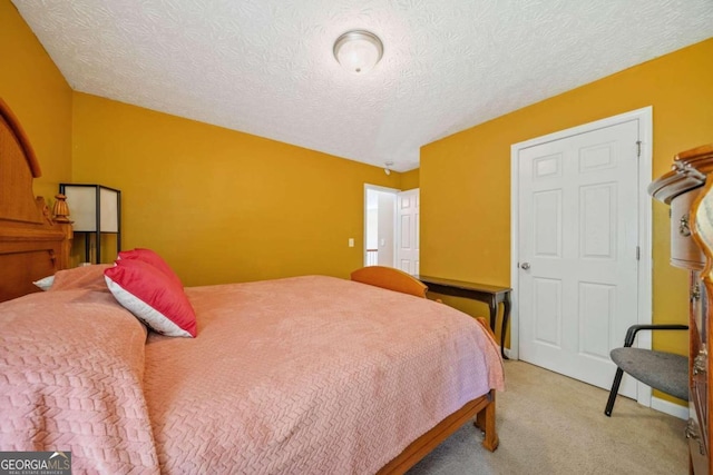 carpeted bedroom featuring a textured ceiling