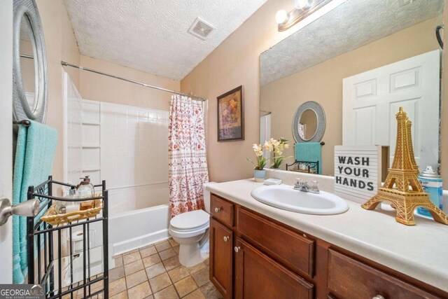 full bathroom featuring vanity, a textured ceiling, tile patterned floors, toilet, and shower / tub combo with curtain