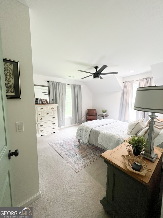 carpeted bedroom featuring vaulted ceiling and ceiling fan