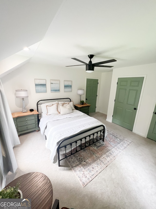 bedroom featuring carpet floors, vaulted ceiling, and ceiling fan