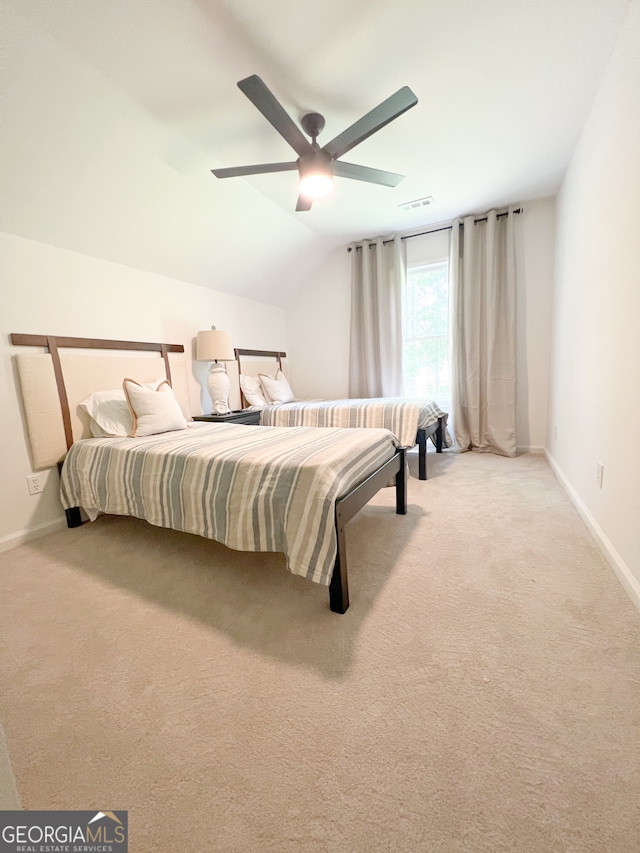 bedroom featuring ceiling fan, light colored carpet, and lofted ceiling