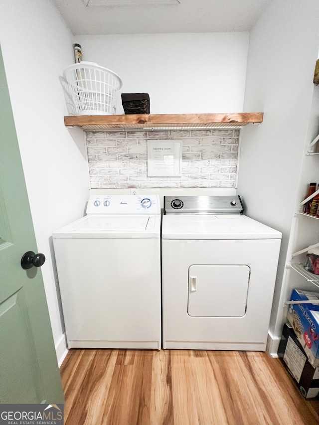 washroom featuring light hardwood / wood-style floors and washing machine and clothes dryer