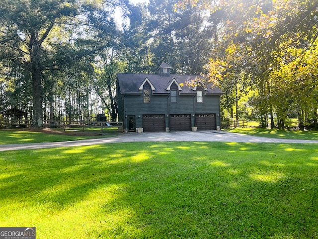 view of front of home featuring a front lawn and a garage