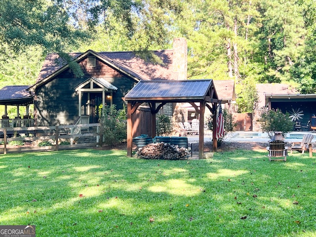 view of front of house featuring a gazebo, a front lawn, and a patio area