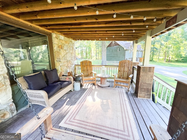 wooden terrace with outdoor lounge area