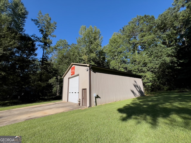 view of outbuilding featuring a yard and a garage