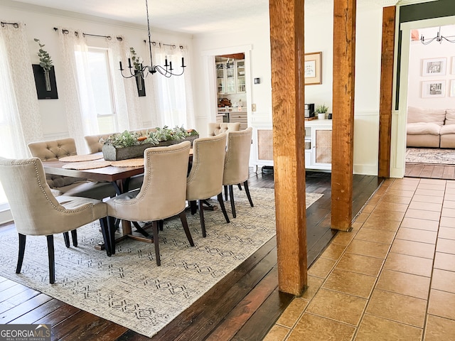 dining area featuring hardwood / wood-style flooring and a notable chandelier