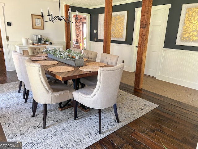 dining room featuring crown molding, dark hardwood / wood-style floors, and a notable chandelier