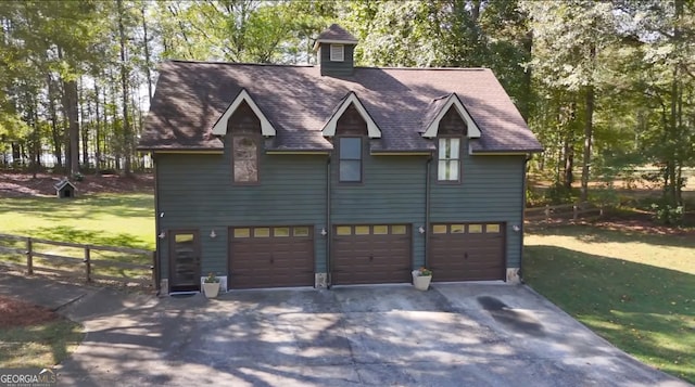 view of front facade with a front yard and a garage