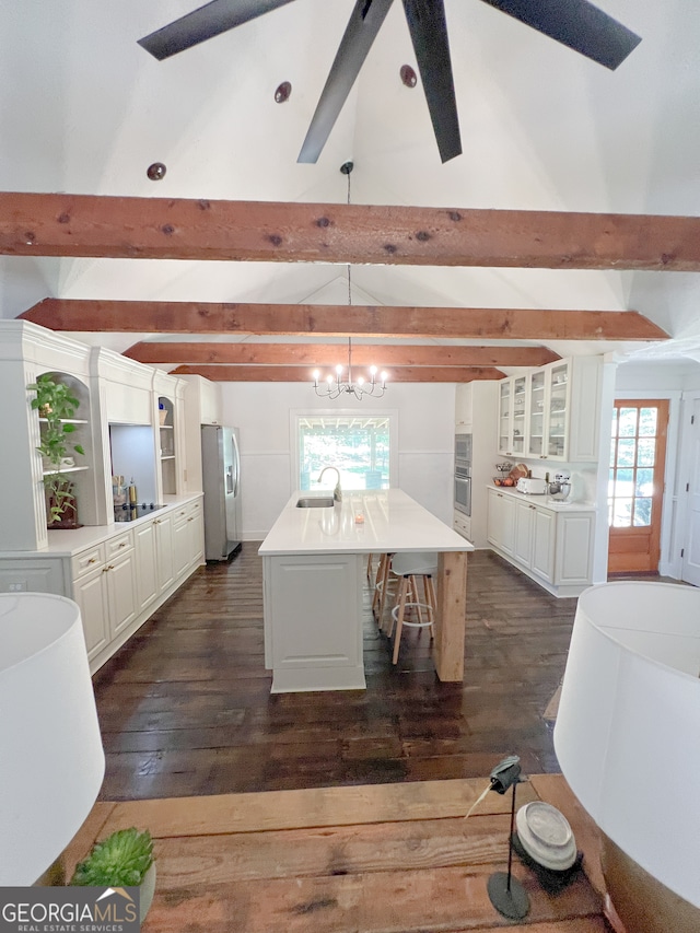 dining area with vaulted ceiling with beams, sink, ceiling fan with notable chandelier, and dark hardwood / wood-style floors