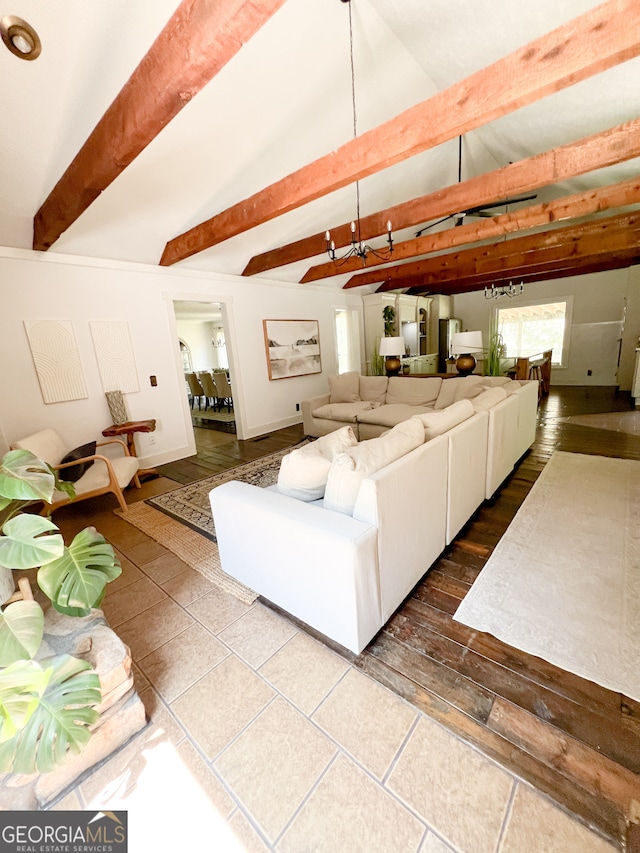 unfurnished living room with vaulted ceiling with beams and dark tile patterned flooring