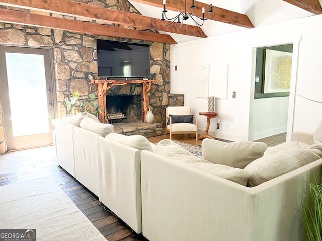 living room featuring beamed ceiling, wood-type flooring, and a fireplace