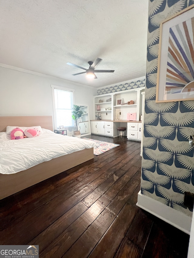 bedroom featuring ceiling fan, dark hardwood / wood-style flooring, and a textured ceiling