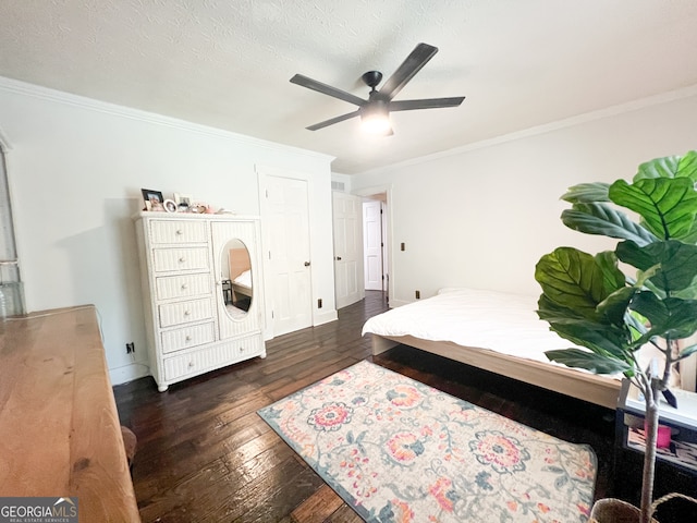 bedroom featuring ceiling fan, crown molding, dark wood-type flooring, and a textured ceiling