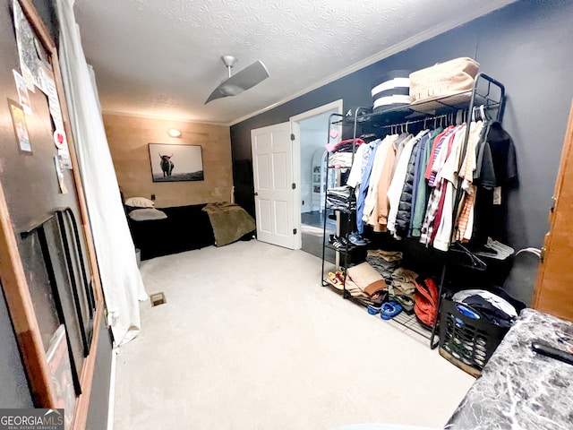 bedroom with a textured ceiling and crown molding