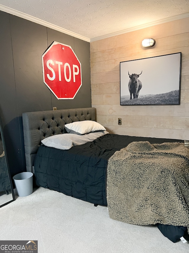 carpeted bedroom featuring a textured ceiling, crown molding, and wood walls