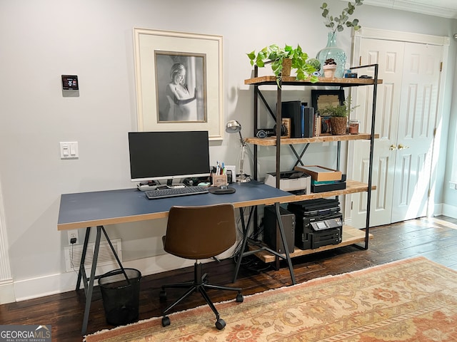 home office featuring dark hardwood / wood-style flooring, built in desk, and crown molding