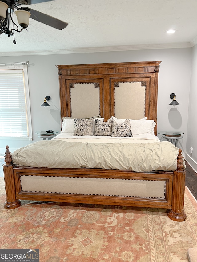 bedroom featuring ceiling fan, crown molding, and light hardwood / wood-style flooring