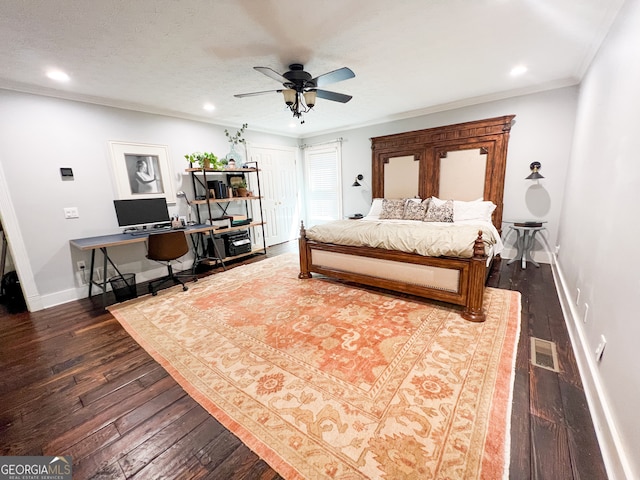 bedroom featuring ceiling fan, dark hardwood / wood-style flooring, a textured ceiling, and ornamental molding