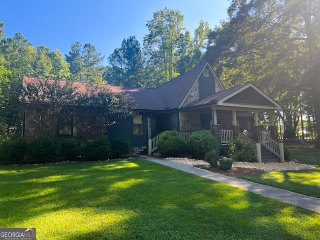 view of front of house featuring a front lawn and covered porch