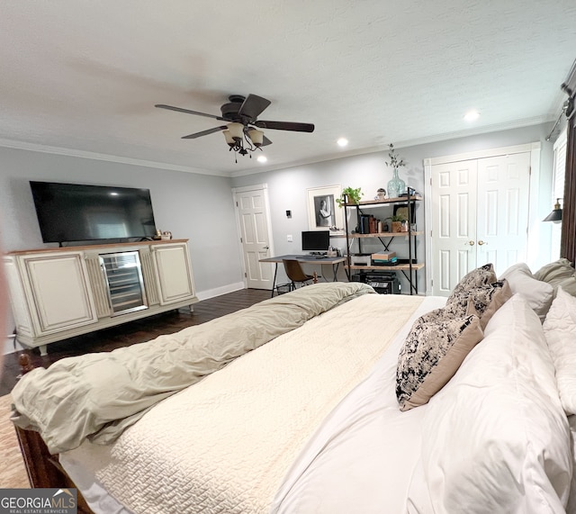 bedroom with ceiling fan, dark hardwood / wood-style flooring, ornamental molding, and a textured ceiling