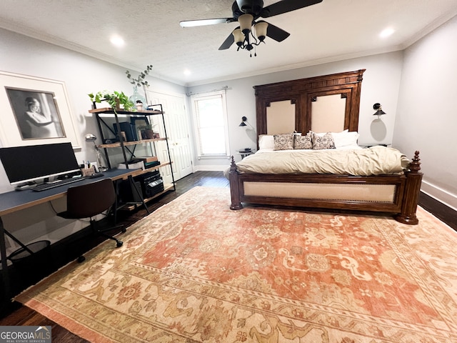 bedroom featuring a textured ceiling, hardwood / wood-style flooring, ceiling fan, and crown molding