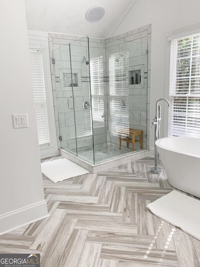 bathroom featuring independent shower and bath, lofted ceiling, and parquet flooring