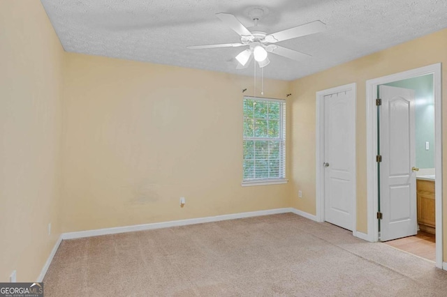 3127 Fields Dr, Stonecrest, GA 30038 - unfurnished bedroom with light carpet, a textured ceiling, and a ceiling fan