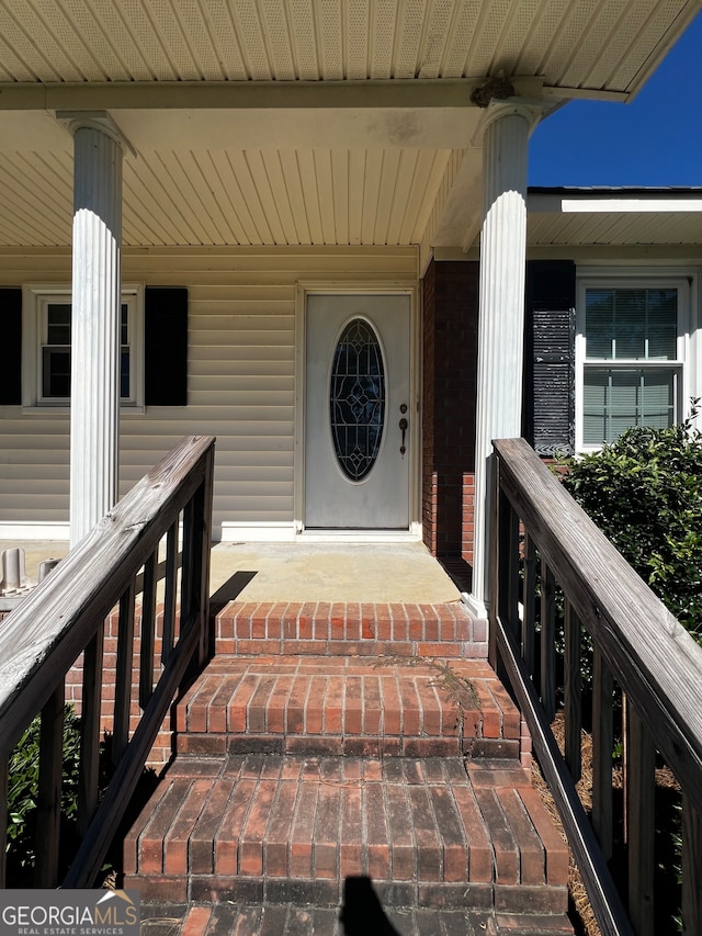 view of exterior entry featuring a porch