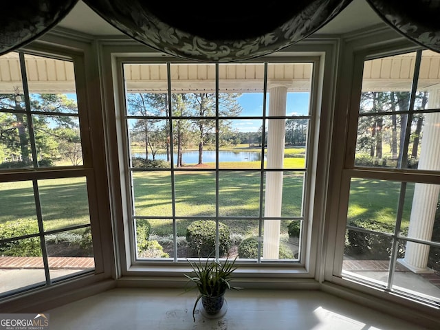 interior space with a water view and a healthy amount of sunlight